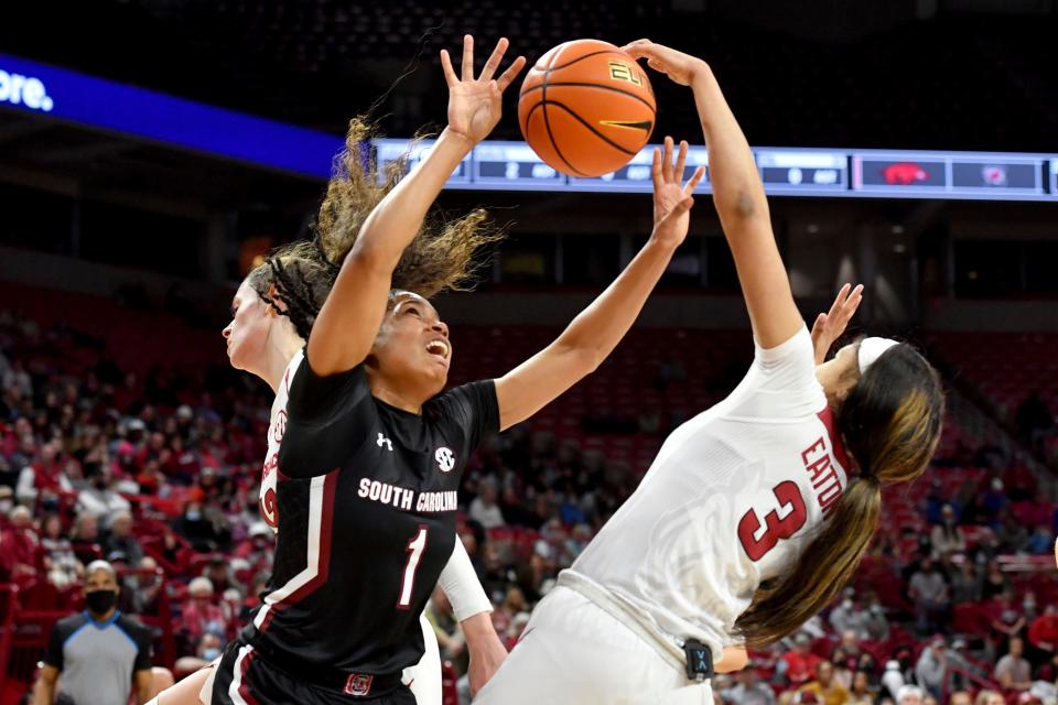 South Carolina guard Zia Cooke (1) and Arkansas guard Elauna Eaton (3) go after a rebound during the first half of an NCAA college basketball game Sunday, Jan. 16, 2022, in Fayetteville, Ark. (AP Photo/Michael Woods)