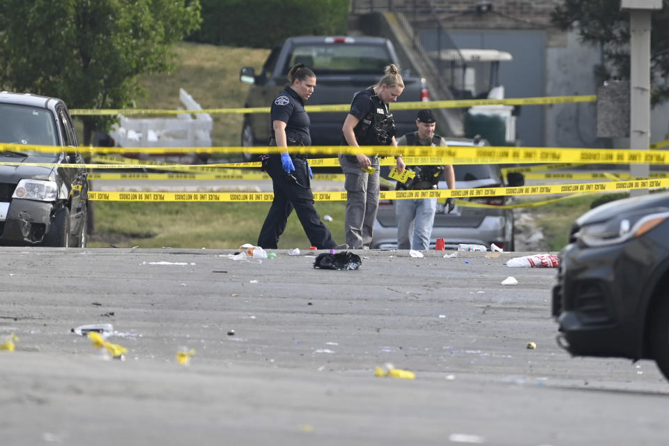 Investigators look over the scene of an overnight mass shooting at a strip mall in Willowbrook, Ill., Sunday, June 18, 2023. (AP Photo/Matt Marton)