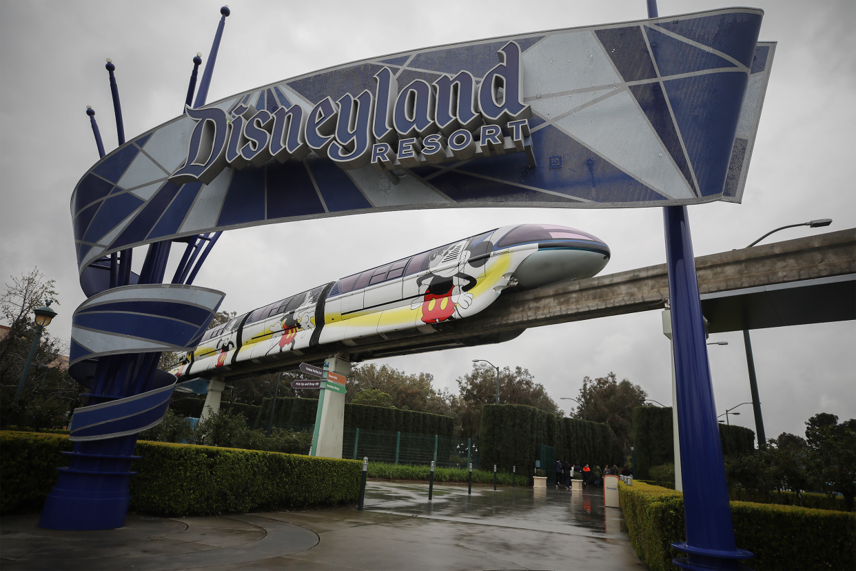 The monorail passes an entrance gate to the famed amusement park Disneyland