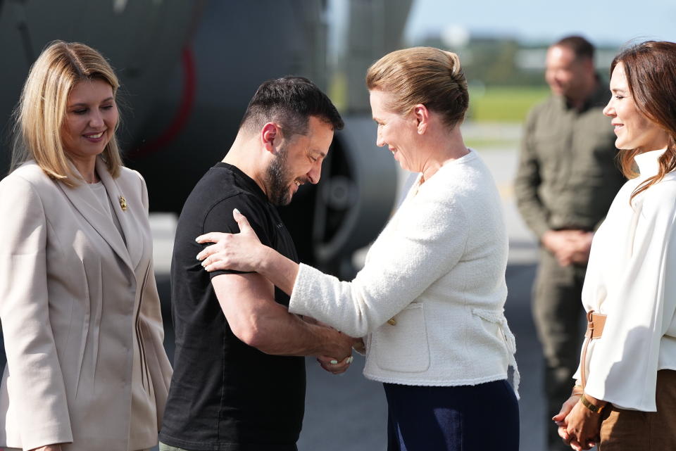 Ukrainian President Volodymyr Zelenskyy and his wife Olena Selenska, left, are welcomed by Denmark's Crown Princess Mary, right, and Prime Minister Mette Frederiksen at Skrydstrup Airbase, in Vojens, Denmark, Sunday, Aug. 20, 2023. (Mads Claus Rasmussen/Ritzau Scanpix via AP)