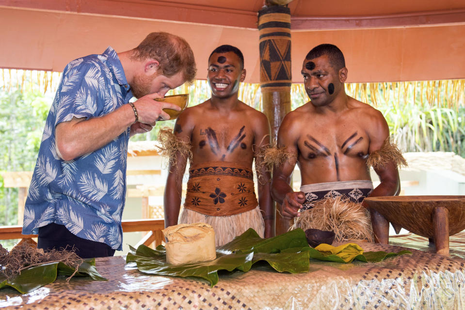 The Duke of Sussex smells a bowl of kava as Joeli Nasqqa, centre, and Eparama Uluiuiti, right, watch during a dedication of the Colo-i-Suva forest to the Queen's Commonwealth Canopy in Suva, Fiji, Wednesday, Oct. 24, 2018. Prince Harry and his wife Meghan are on day nine of their 16-day tour of Australia and the South Pacific. (Dominic Lipinski/Pool Photo via AP)