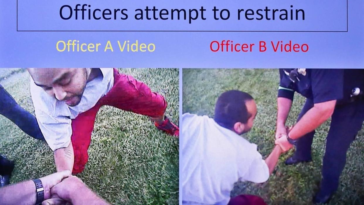 This image from Topeka police body camera video shows officers struggling with Dominique White, who had a handgun in his left pocket, before he broke free, started to run away and was fatally shot in September 2017.