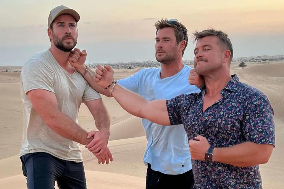 <p>Chris Hemsworth/Instagram</p> The Hemsworth brothers strike a pose in the desert during their trip to Abu Dhabi in Nov. 2023. 