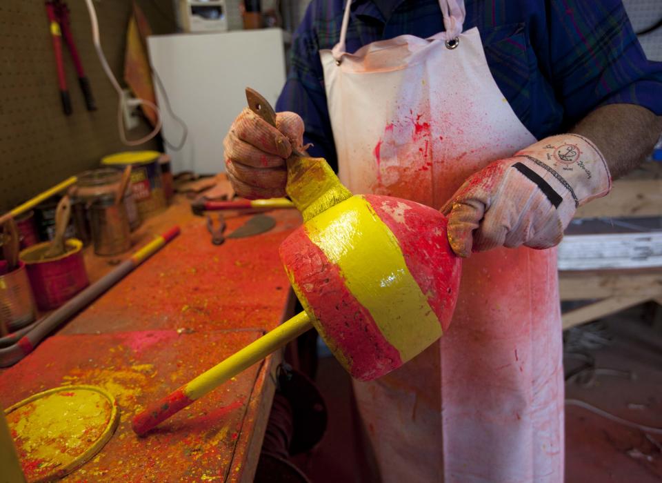 Lobsterman Blake Wotten applies a fresh coat of paint to a buoy in Friendship, Maine, Thursday, May 10, 2012. As lobstermen are preparing for the upcoming season, the recent sinking of two boats is bringing back memories of territorial tensions that escalated to a shooting two years ago. (AP Photo/Robert F. Bukaty)