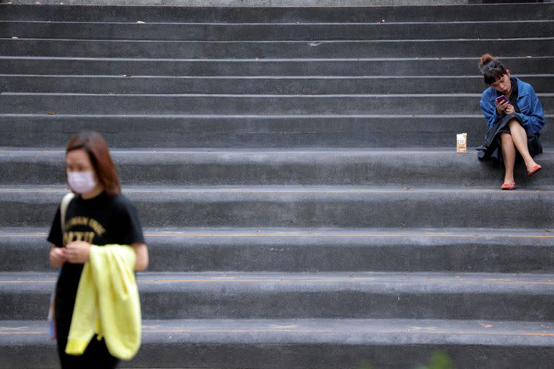 FILE PHOTO: Woman sits on a staircase in Taipei