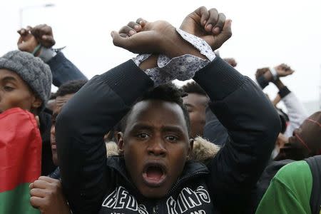 Ethiopian migrants, members of the Oromo community, react as they leave the "Jungle" to be transfered to reception centers during the start of the dismantlement of the camp in Calais, France, October 24, 2016. REUTERS/Pascal Rossignol