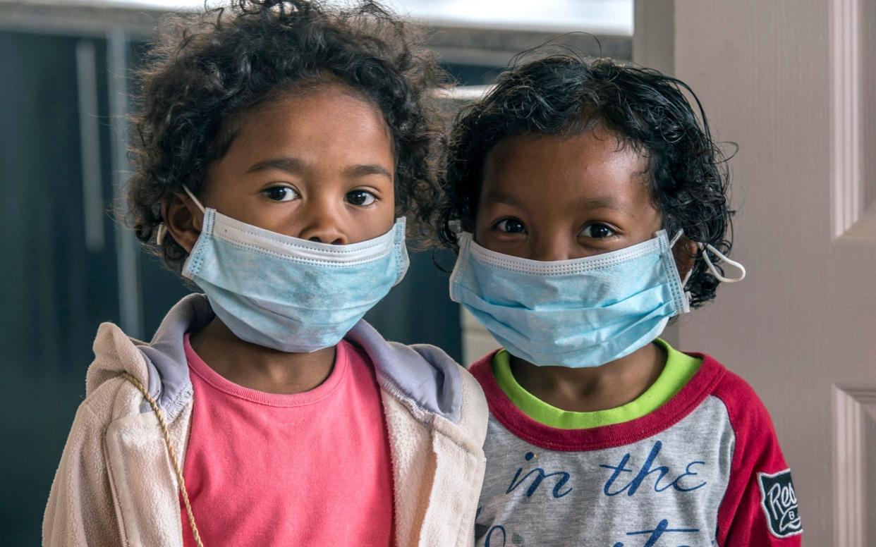 Children at a school in Madagascar wear face masks to protect them from a plague outbreak - AP