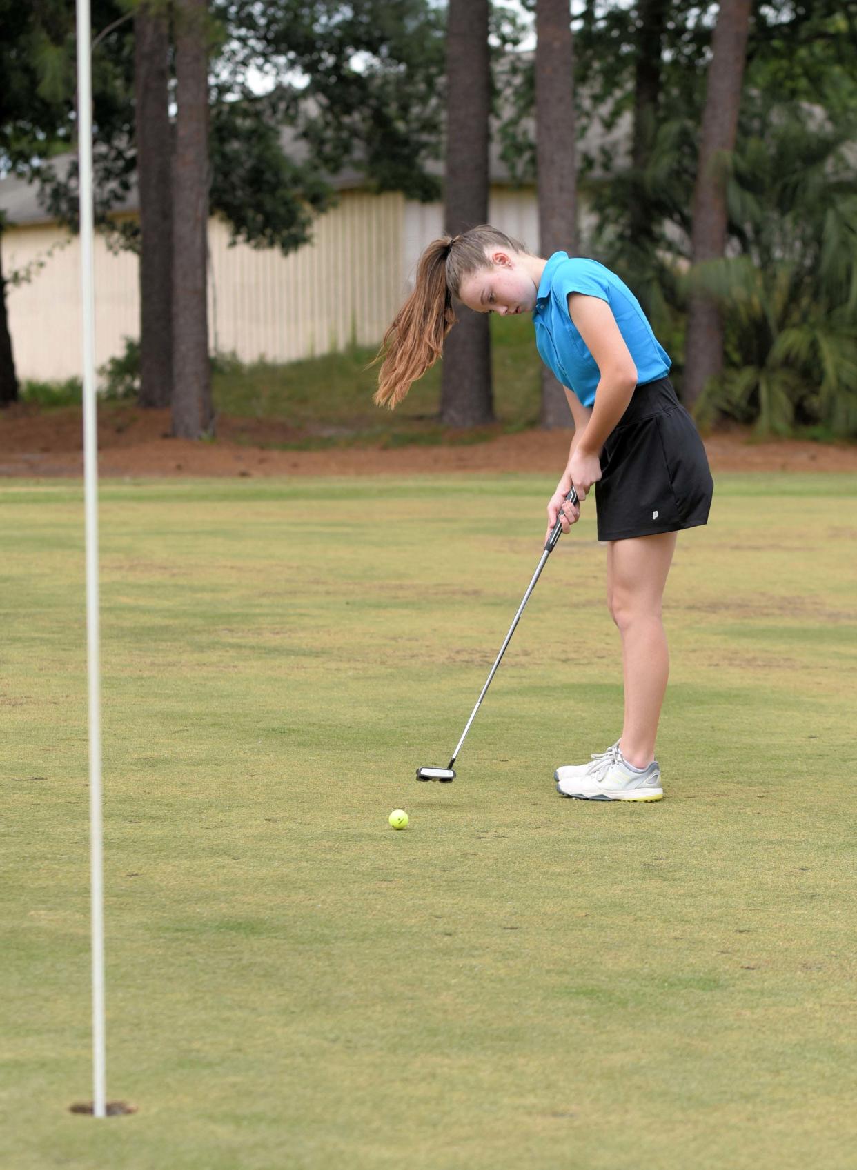 Effingham County High School freshman Natalie Altman makes a 20-foot putt at golf practice Thursday, May 12, 2022, at Lost Plantation in Rincon.