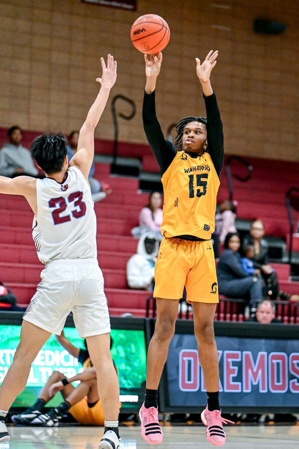 Waverly's Deunte Phifer, right, shoots as Okemos' Christian Chiou defends during the second quarter on Monday, Feb. 12, 2024, at Okemos High School.