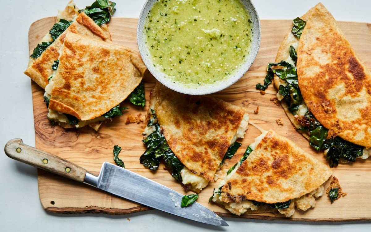 <p>Parade</p><p>Creamy beans, gooey cheese and earthy kale are folded into a griddled tortilla for a filling treat.</p><p><strong>Get the recipe: <a href="https://parade.com/855341/parade/white-bean-and-kale-quesadillas/" rel="nofollow noopener" target="_blank" data-ylk="slk:White Bean and Kale Quesadillas;elm:context_link;itc:0;sec:content-canvas" class="link rapid-noclick-resp"><em>White Bean and Kale Quesadillas</em></a></strong></p>