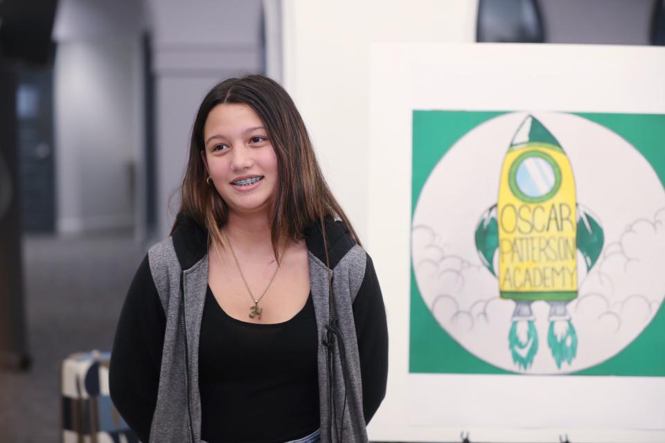 Emma York talks about her entry in the logo design contest for Oscar Patterson Elementary on Feb. 3. Emma's design of a rocket launching was chosen to represent the academy.