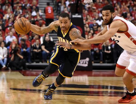 Indiana Pacers guard George Hill (3) dribbles past Toronto Raptors guard Cory Joseph (24) in game seven of the first round of the 2016 NBA Playoffs at Air Canada Centre. Mandatory Credit: Dan Hamilton-USA TODAY Sports