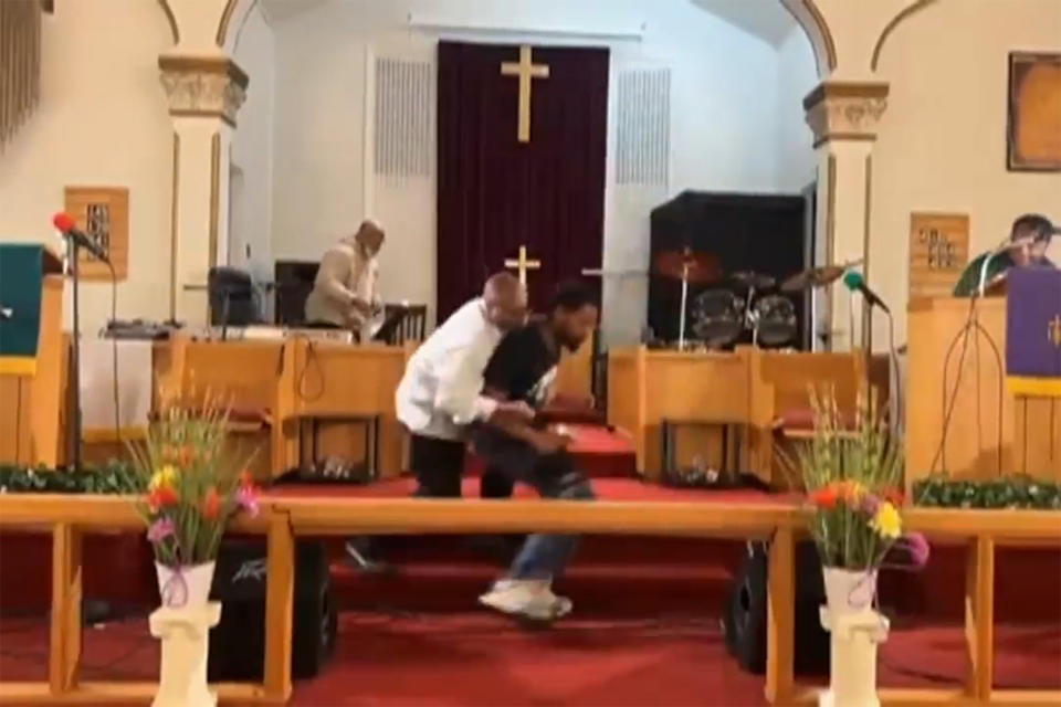 In this image taken from video, Bernard J. Polite, 26, right, is tackled by a congregant after trying to shoot Pastor Glenn Germany at the Jesus Dwelling Place church, in North Braddock, Pa., May 5, 2024. The attempted shooting during the church service failed when Polite's gun didn't fire and then was restrained. (Glenn Germany via AP)