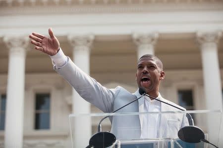 Sacramento Mayor Kevin Johnson greets the crowd during a parade and celebration for Alek Skarlatos, Spencer Stone, and Anthony Sadler, who helped thwart an attack on a French train last August, in Sacramento, California, September 11, 2015. REUTERS/Max Whittaker