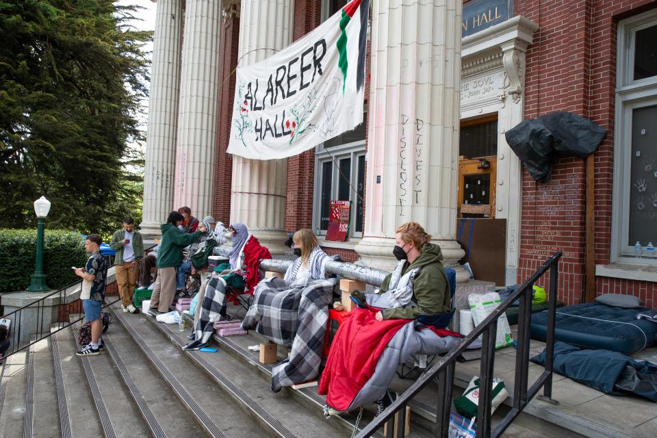 Protesters block the steps of Johnson Hall at the University of Oregon.