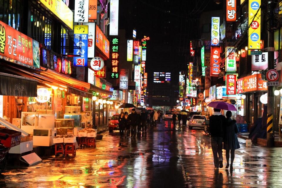 Colorful neon reflections of wet Seoul street taken at night at rain in Korea, Asia.