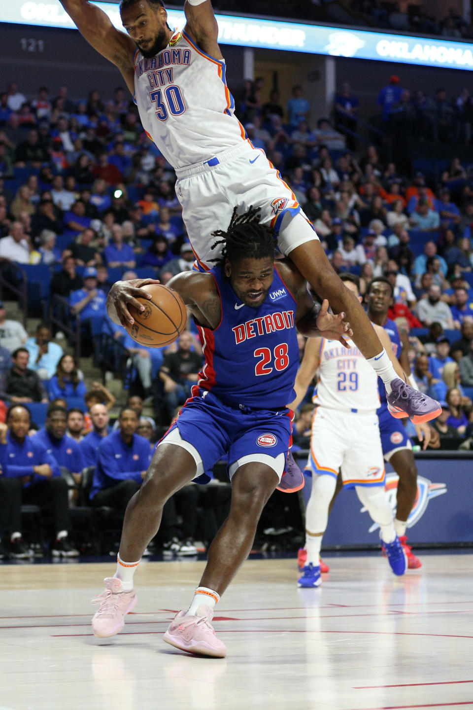 Oct 19, 2023; Tulsa, Oklahoma, USA; Detroit Pistons center Isaiah Stewart (28) is fouled by Oklahoma City Thunder center Olivier Sarr (30) in the first half at BOK Center. Mandatory Credit: Joey Johnson-USA TODAY Sports