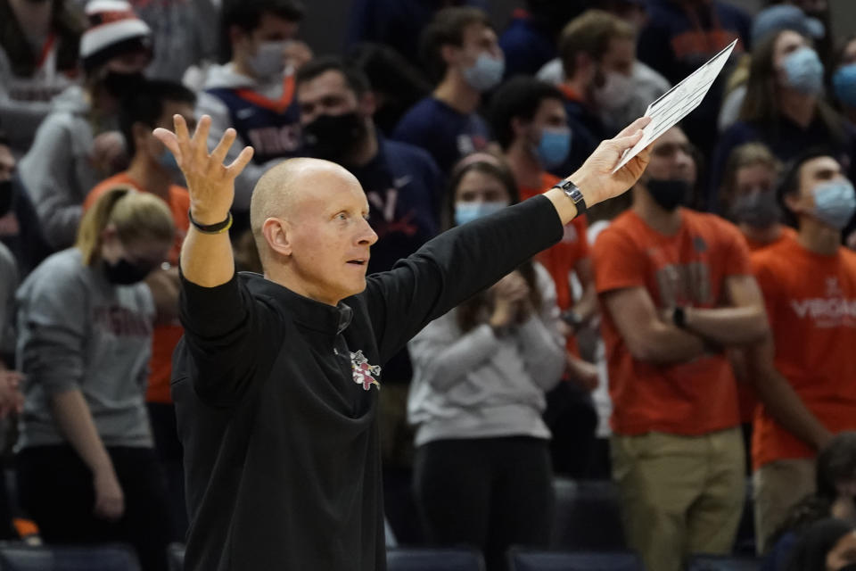 Louisville head coach Chris Mack reacts to a call during the first half of an NCAA college basketball game against Virginia, Monday Jan. 24, 2022, in Charlottesville, Va. (AP Photo/Steve Helber)