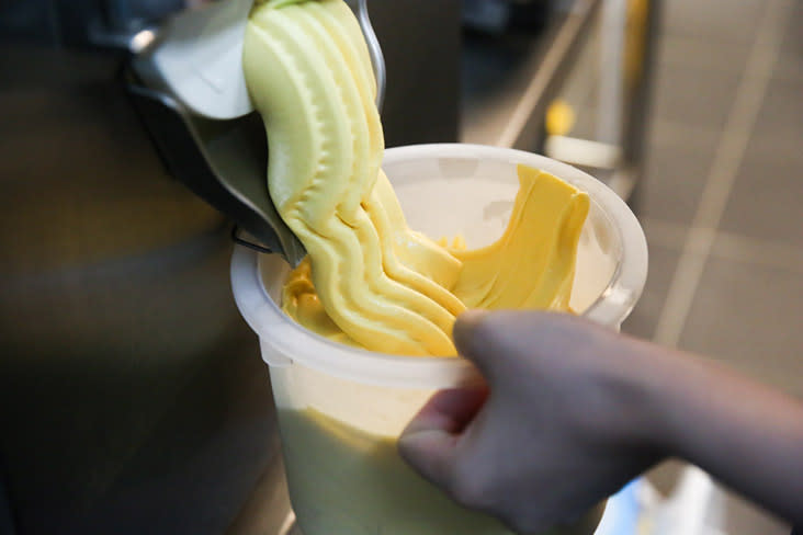 The mango ice cream is churned and ready to be used for their ice cream cakes.