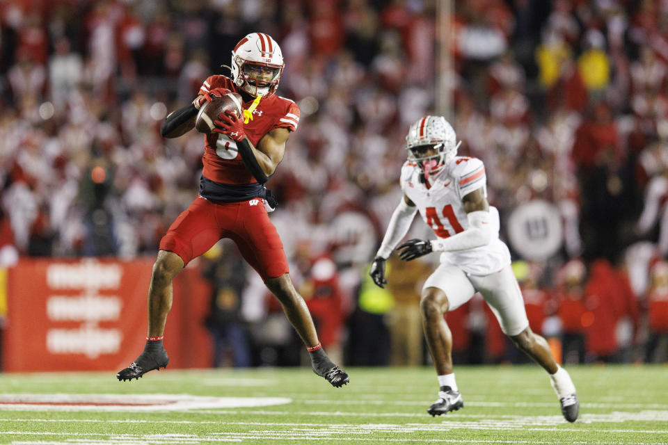 Oct 28, 2023; Madison, Wisconsin, USA; Wisconsin Badgers wide receiver Will Pauling (6) catches a pass in front of Ohio State Buckeyes safety Josh Proctor (41) during the fourth quarter at Camp Randall Stadium. Mandatory Credit: Jeff Hanisch-USA TODAY Sports