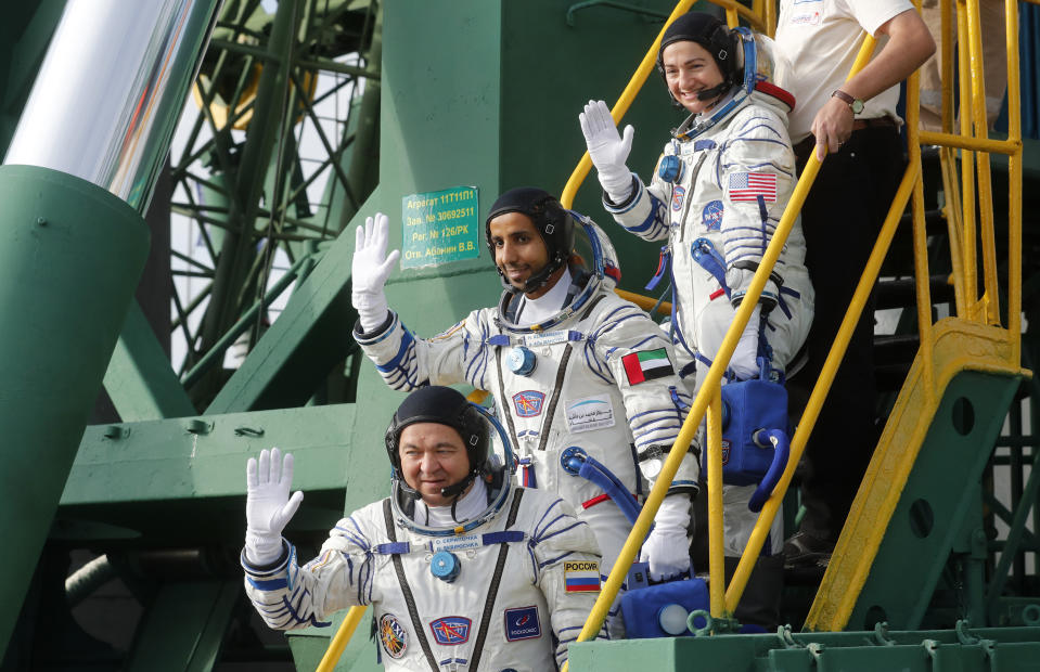 United Arab Emirates astronaut Hazza Al Mansouri, centre, Russian cosmonaut Oleg Skripochka, bottom, and U.S. astronaut Jessica Meir, top, members of the main crew to the International Space Station (ISS), board the Soyuz MS-15 spacecraft for the launch at the Russian leased Baikonur cosmodrome, Kazakhstan, Wednesday, Sept. 25, 2019. (Maxim Shipenkov/Pool Photo via AP)