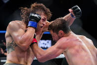 Brendan Loughnane, right, and Tyler Diamond trade punches during a Professional Fighters League mixed martial arts bout in Atlantic City, N.J., Thursday, June 10, 2021. (AP Photo/Matt Rourke)