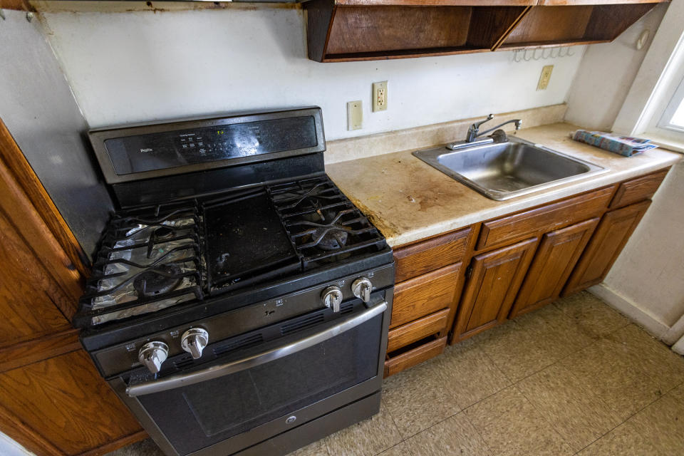 A kitchen in need renovation is seen at the Lexington Gardens public housing complex in Watertown, Mass., on Aug. 2, 2023. A WBUR and ProPublica investigation found that nobody is living in nearly 2,300 state-funded apartments, with most sitting empty for months or years. The state pays local housing authorities to maintain and operate the units whether they're occupied or not. (Jesse Costa/WBUR via AP)