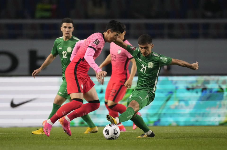 South Korea's Son Heung-min, left, fights for the ball against Turkmenistan's Halmammedov Rovshengeldi during their Asian zone Group H qualifying soccer match for the FIFA World Cup Qatar 2022 at Goyang stadium in Goyang, South Korea, Saturday, June 5, 2021. (AP Photo/Lee Jin-man)