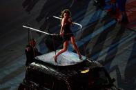 British singer Victoria Beckham of The Spice Girls band performs on top of a London taxi during the closing ceremony of the 2012 London Olympic Games at the Olympic stadium in London