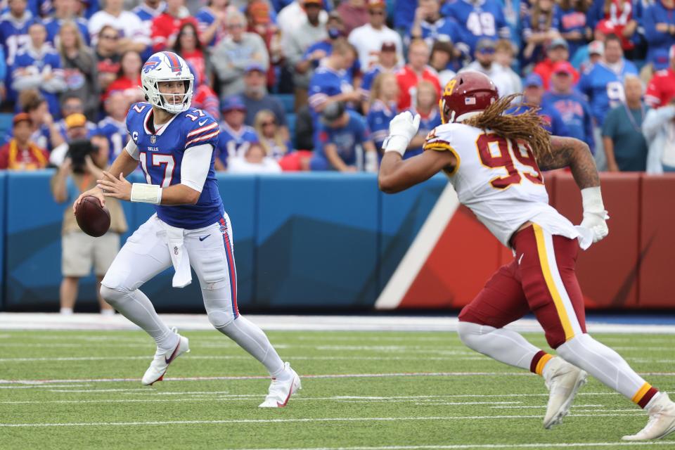 Bills quarterback Josh Allen escapes Washington's Chase Young when they met in 2021.