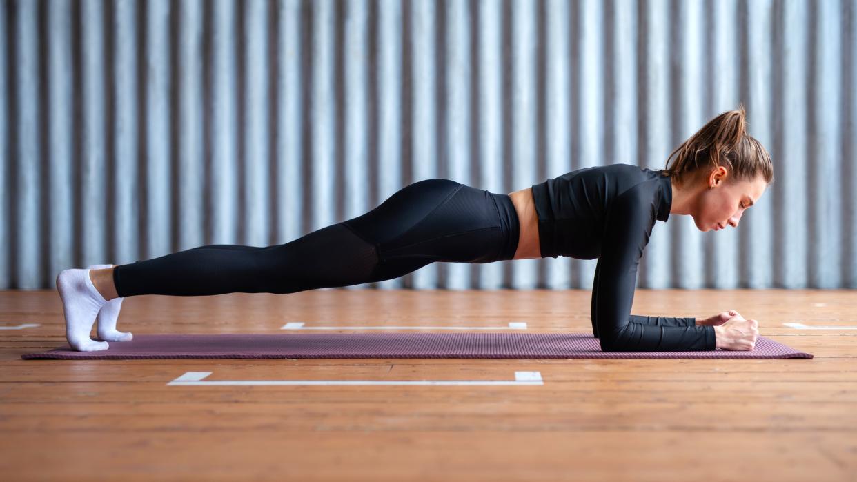  A photo of a woman doing a plank . 