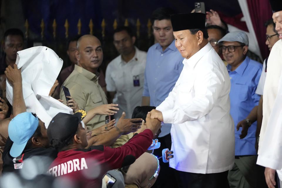 Indonesia's Defense Minister Prabowo Subianto, right, is congratulated by supporters after winning the Feb. 14 election in Jakarta, Indonesia, Wednesday, March 20, 2024. Subianto was announced the winner of last month's presidential election Wednesday over two former governors who have vowed to contest the result in court over alleged irregularities. (AP Photo/Achmad Ibrahim)