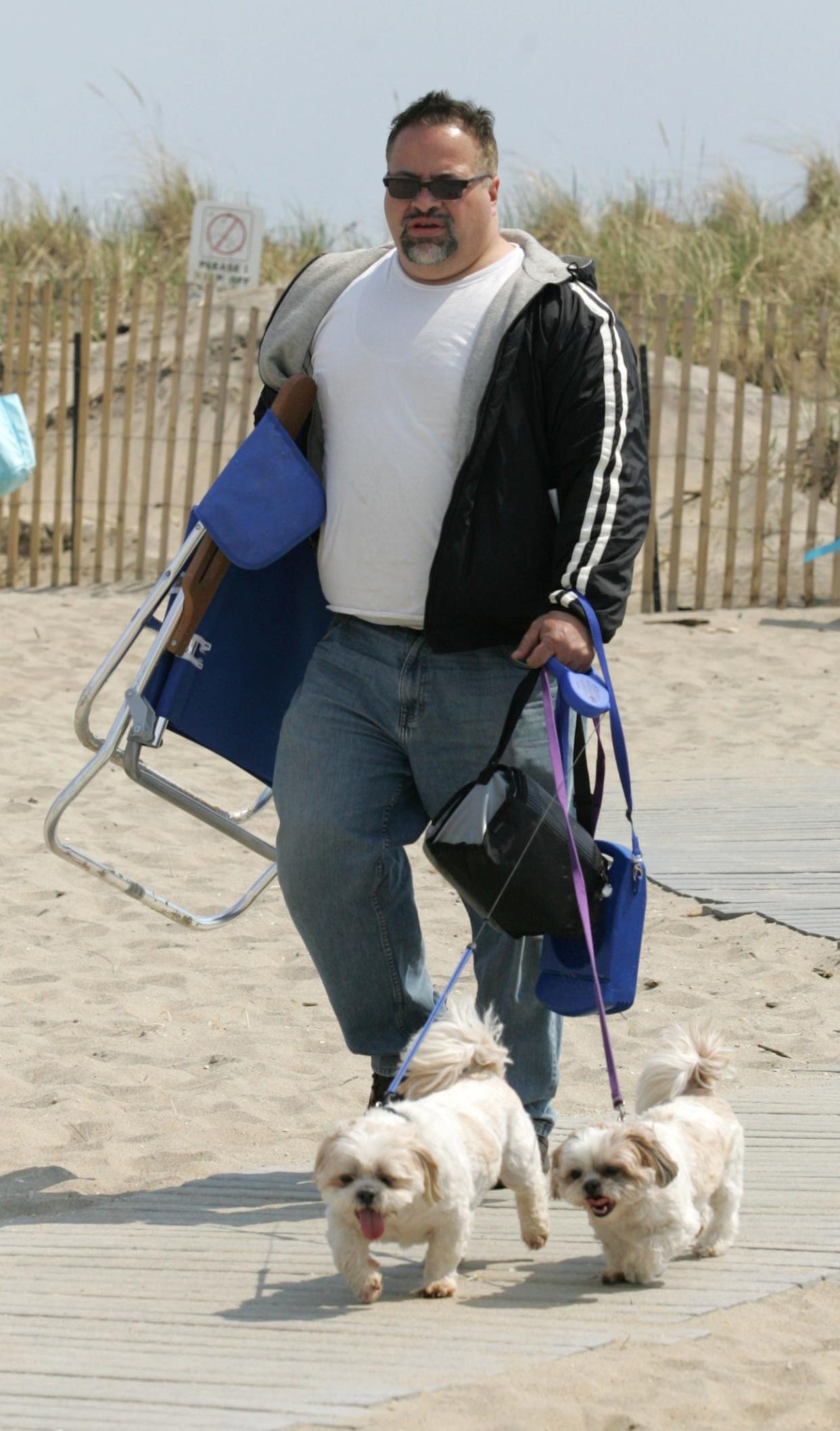 Mike DeGeorge of Middletown, walks his Shitzu dogs Chester and Roxy right on the beach in Sea Bright on April 11, 2010.