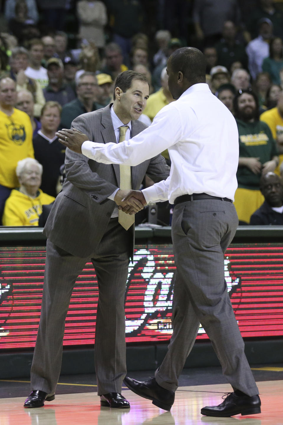 Baylor coach Scott Drew, left, shakes hands with Oklahoma State coach Mike Boynton, right, after Boynton was ejected during the second half of an NCAA college basketball game Saturday, Feb. 8, 2020, in Waco, Texas. (AP Photo/Rod Aydelotte)