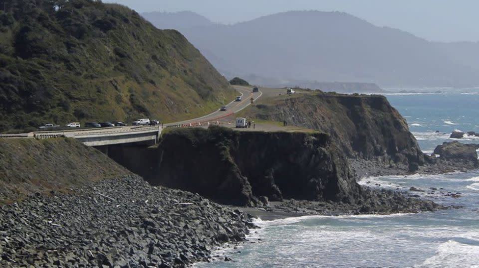 Investigators with the California Highway Patrol work at the scene where a couple and several of their children plunged in their SUV off. Source: AP