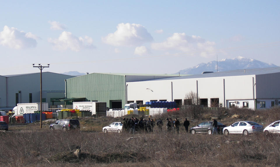 Police secure the area around a factory in the northern city of Komotini, about 800 kilometers (500 miles) northeast of Athens, Thursday, March 1, 2012. An unemployed man shot and wounded two people and took two others hostage at the plastics factory. The shooter, who was fired from the factory eight months ago, burst into the site with a with a shotgun, wounding a member of the management and another employee, police said. (AP Photo/Paratiritis Thrakis, Thomas Stamoulis)