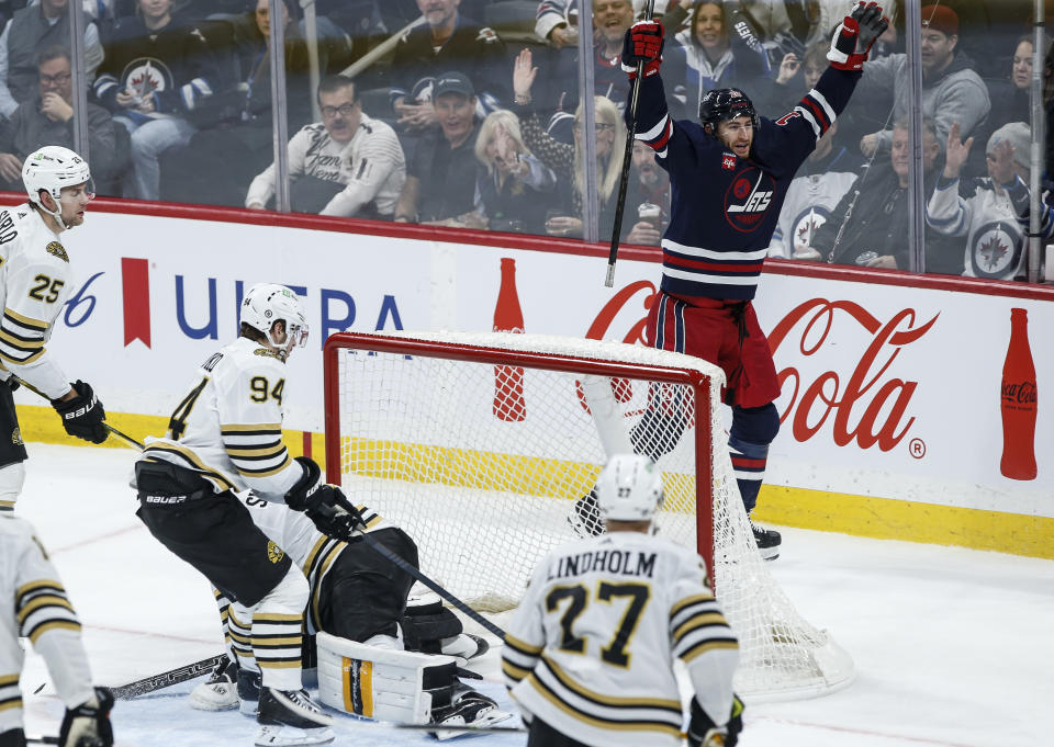 Winnipeg Jets' Gabriel Vilardi (13) celebrates his goal on Boston Bruins goaltender Jeremy Swayman (1) during the second period of an NHL hockey game Friday, Dec. 22, 2023, in Winnipeg, Manitoba. (John Woods/The Canadian Press via AP)