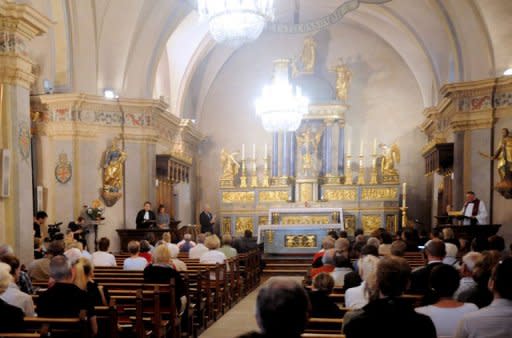 People and relatives of the victims killed in an avalanche in the French Alps attend an ecumenical prayer at the Saint-Michel church. Nine candles burned on the altar of the church, one for each of the foreign climbers killed by an avalanche two days earlier