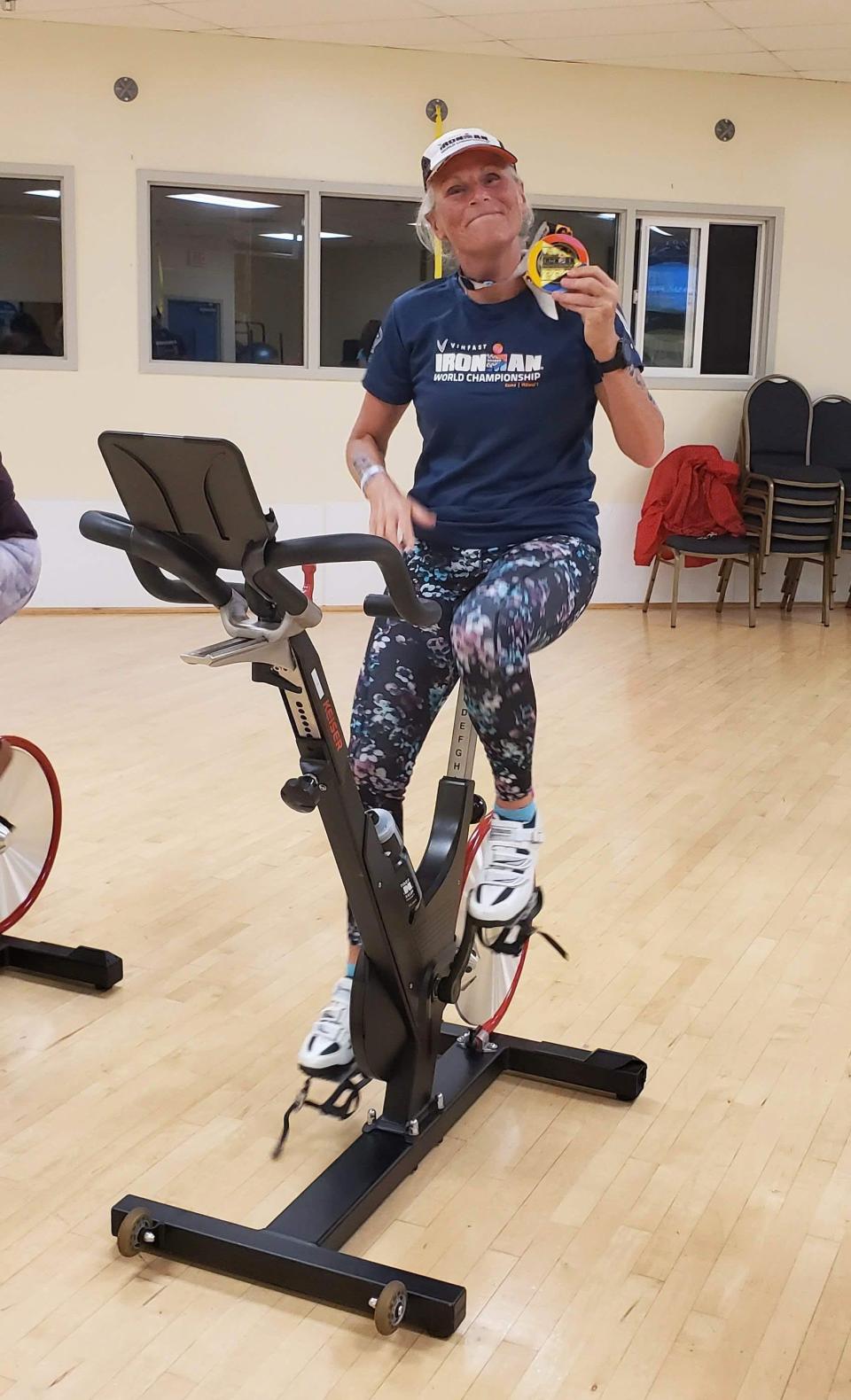 Leslie Maurice poses during an early morning spin class at the Bremerton YMCA. Maurice is a regular at the Y and on roads around Kitsap County, training as part of a passion for triathlons that she picked up several years ago.