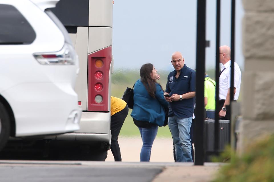 State Rep. Chris Turner, center, arrives at Austin-Bergstrom International Airport on July 12 as more than 50 Democratic House members prepare to fly to Washington.