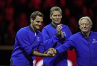 Team Europe's Captain Bjorn Borg, right, holds the hands of his player Roger Federer at the end of the Laver Cup tennis tournament at the O2 arena in London, Sunday, Sept. 25, 2022. (AP Photo/Kin Cheung)