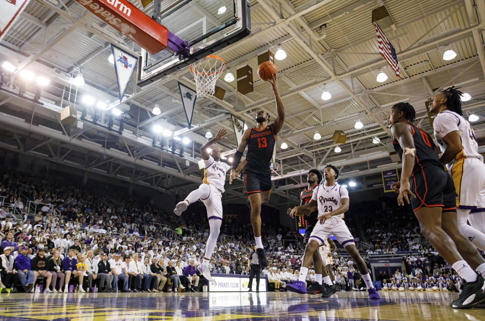 Houston's J'Wan Roberts (13) shoots next to East Carolina's RJ Felton (3) during the first half of an NCAA college basketball game in Greenville, N.C., Saturday, Feb. 25, 2023. (AP Photo/Ben McKeown)