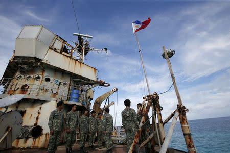 Members of Philippine Marines is pictured at BRP Sierra Madre, a dilapidated Philippine Navy ship that has been aground since 1999 and became a Philippine military detachment on the disputed Second Thomas Shoal, part of the Spratly Islands, in the South China Sea March 29, 2014. REUTERS/Erik De Castro