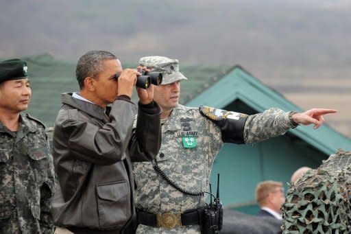 US President Barack Obama looks towards North Korea from Observation Post Ouellette, during a visit to the Joint Security Area of the Demilitarized Zone (DMZ) near Panmunjom on the border between North and South Korea. Obama said it was unclear who was "calling the shots" in North Korea under its new young leader and stepped up demands for Pyongyang to abort its planned rocket launch