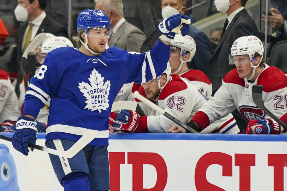 Toronto Maple Leafs forward William Nylander (88) celebrates his game-winning goal as he skates by the Montreal Canadiens bench during the third period of an NHL hockey game in Toronto on Wednesday, Oct. 13, 2021. (Evan Buhler/The Canadian Press via AP)