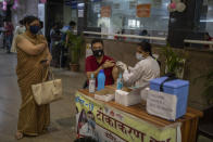 A man gets a COVID- 19 vaccine at a government hospital in Noida, a suburb of New Delhi, India, Wednesday, April 7, 2021. India hits another new peak with 115,736 coronavirus cases reported in the past 24 hours with New Delhi, Mumbai and dozens of other cities imposing night curfews to check the soaring infections. (AP Photo/Altaf Qadri)