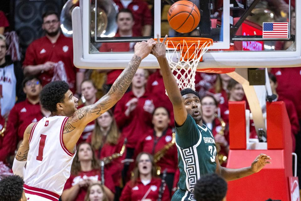 Indiana center Kel'el Ware and Michigan State forward Xavier Booker reach for the ball during the first half on Sunday, March 10, 2024, in Bloomington, Indiana.