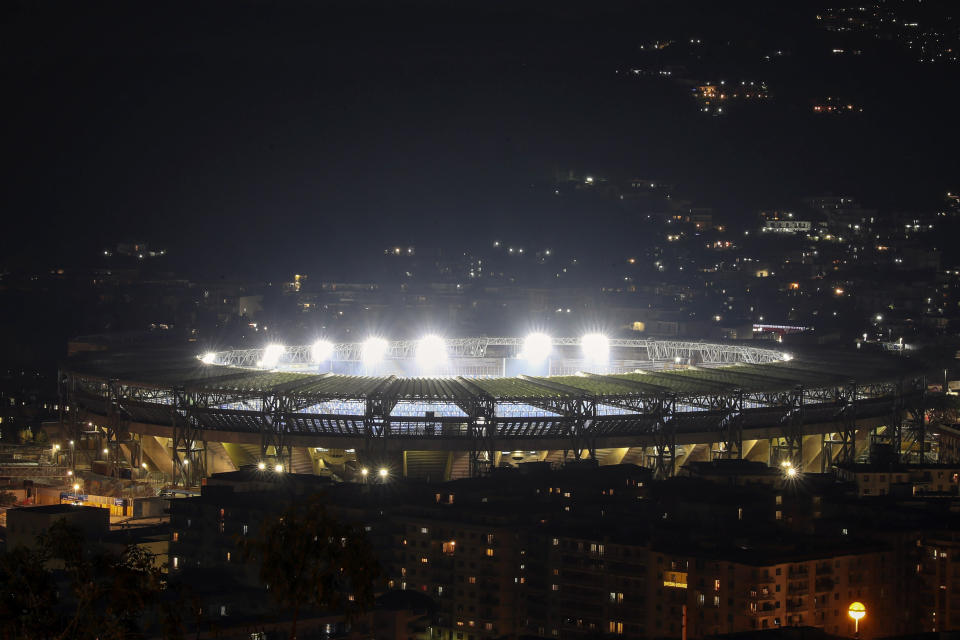 The San Paolo Stadium is illuminated to honor soccer legend and former Napoli player Diego Armando Maradona, in Naples, Italy, Wednesday, Nov. 25, 2020. Diego Maradona has died. The Argentine soccer great was among the best players ever and who led his country to the 1986 World Cup title before later struggling with cocaine use and obesity. He was 60. (AP Photo/Salvatore Laporta)