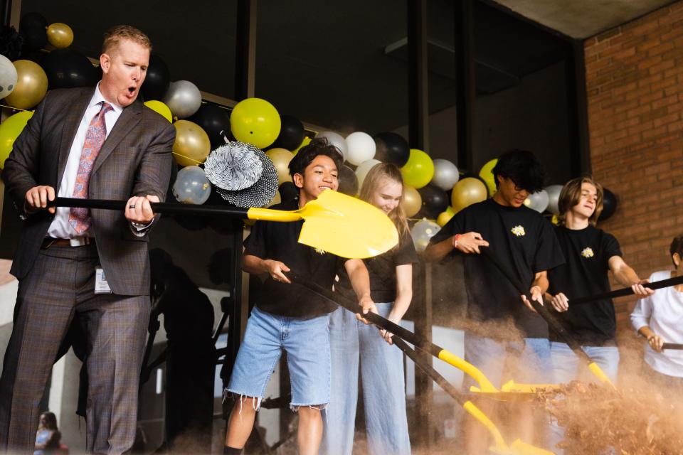 Members of Cottonwood High School’s staff, students and parents dig during a groundbreaking event for a teen resource center at Cottonwood High School in Murray on Thursday, June 1, 2023. | Ryan Sun, Deseret News