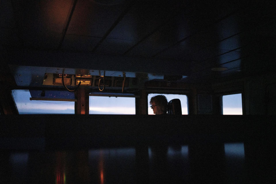 The captain of Sea Shepherd Global's Allankay works on the bridge of the ship on March 3, 2023. The conservation group operates the Dutch-flagged vessel. (AP Photo/David Keyton)